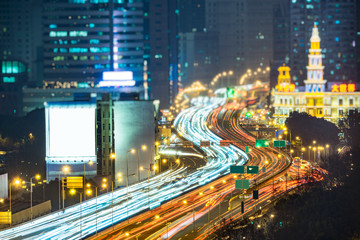 Fototapeta na wymiar urban traffic road with cityscape in background at night in Hong Kong,China.
