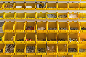 Fototapeta premium Plastic yellow boxes with instruments on wall 