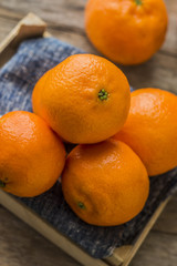 Mandarin Oranges - mandarin oranges on a rustic wooden board.