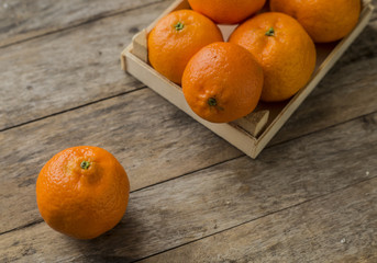 Mandarin Oranges - mandarin oranges on a rustic wooden board.