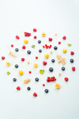 Mix of berries isolated over white background table.