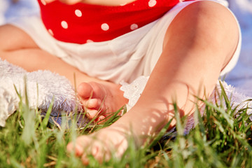 Closeup legs of little girl on soft pillow