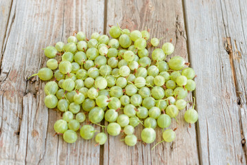 Gooseberry on a wooden table. It can be used as a background