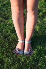 Legs of a girl in sandals