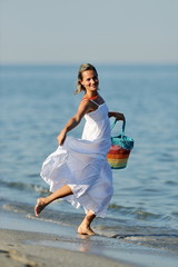 young happy woman on the beach in summer