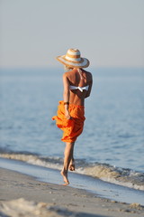 young happy woman on the beach in summer