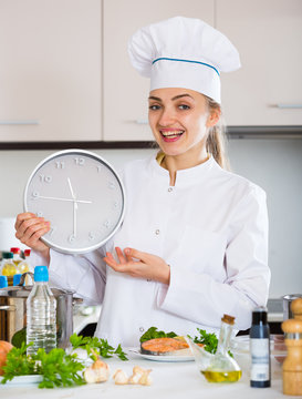 Female chef counting time down for cooling fish