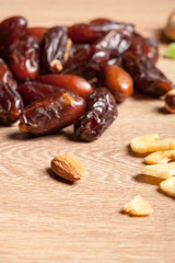 Mix of different dried fruits on wooden background. Healthy raw organic snack