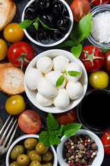 mozzarella, fresh ingredients for the salad and bread, vertical, top view