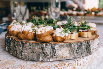 Beautifully decorated catering banquet table with different food snacks and appetizers on corporate christmas birthday party event or wedding celebration