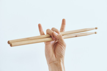 Hand on white isolated background, rock, drumsticks