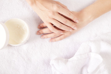 Obraz na płótnie Canvas Closeup of female hands applying cream