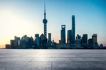 empty brick platform with Shanghai skyline in background.