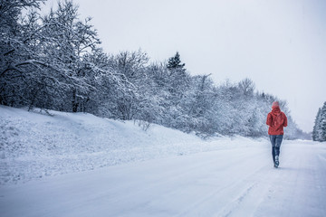 Woman Running Alone with Motion Blur during Cold Snowy day of Winter in Canada