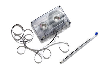 Retro cassette with loose tape over a white background    