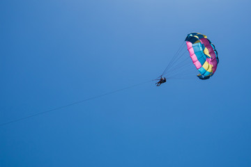 Parasailing against a blue sky