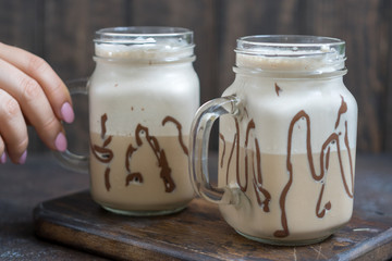 Cold coffee drink frappe frappuccino with whipped cream and chocolate syrup