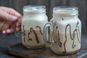 Cold coffee drink frappe frappuccino with whipped cream and chocolate syrup