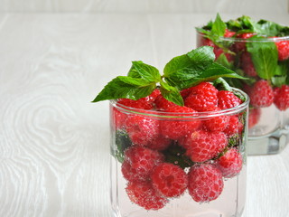 Cool mint drink with raspberries. Copy space.