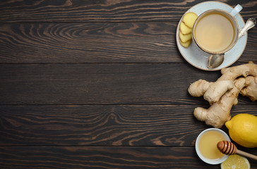 Ginger root tea with lemon and honey on wooden background, copy space