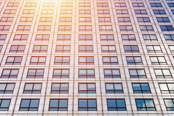 Fototapeta premium Cityscape featuring modern office exterior from a low angle at sunset.