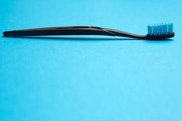 Black toothbrush with blue bristle