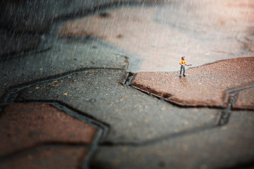 figure toy playing guitar during hard rain fall.