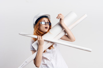 Beautiful young woman engineer on white isolated background holds blueprints