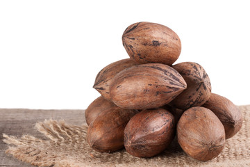a bunch of pecan nuts on the old board with white background