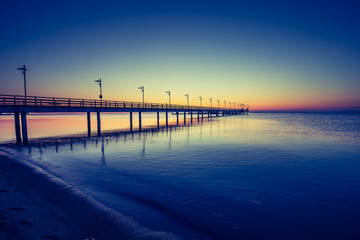 Amazing sunrise on the pier at the seaside. Gdynia Orlowo, Poland