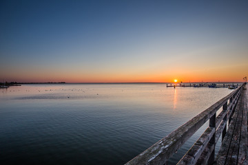 Fototapeta premium Amazing sunrise on the pier at the seaside. Gdynia Orlowo, Poland 
