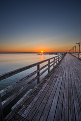 Obraz na płótnie Canvas Amazing sunrise on the pier at the seaside. Gdynia Orlowo, Poland 