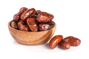 Dates in a wooden bowl isolated on white background