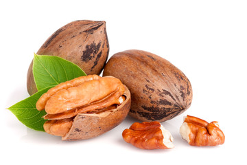 Three pecan with leaves isolated on white background