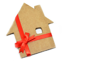 House from cardboard with ribbon