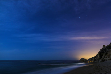 Night sky over the coastline