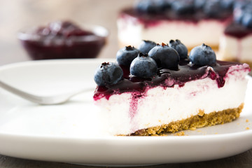 Piece of blueberry cheesecake on gray stone
