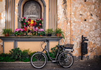 Fototapeta na wymiar Bike parked neat romantic rustic wall 
