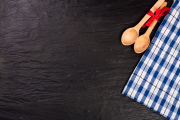 blue checkered tablecloth on the black stone table with copy space for your text. Top view