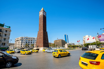 Cityscape with clock tower monument on central square in Tunis city. Tunisia, North Africa