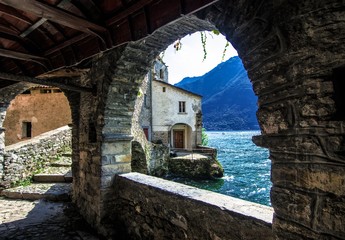 picturesque view of Como Lake with medieval stone bridge