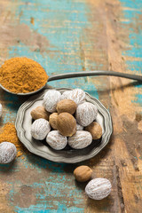 Nutmeg powder. Macro view whole nuts and grated muscat nuts.