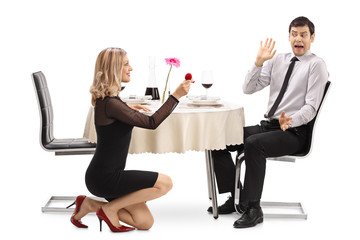 Obraz premium Young woman proposing to her shocked boyfriend