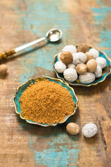 Nutmeg powder. Macro view whole nuts and grated muscat nuts.