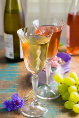Cold summer wines, white and rose, served in beautiful glasses on terrace in cafe with romantic flowers