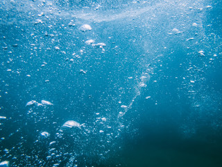 Fototapeta na wymiar Underwater turquoise texture in ocean. Bubbles in sea. 