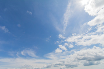 Clear blue sky background with white clouds.