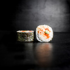 Sushi rolls on black background. Traditional  japan food. 