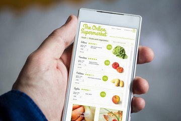 holding online supermarket smartphone