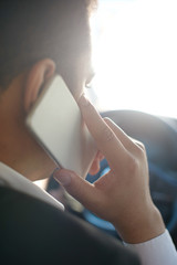 Businessman talking by the phone in the car